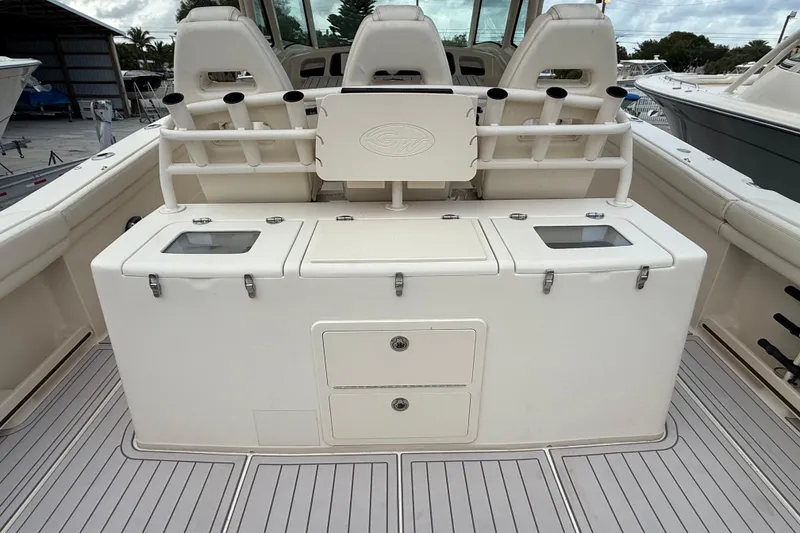Slide: The Image of 2020 Grady-White Canyon 376 boat interior with fishing rod holders and storage compartments. - 31