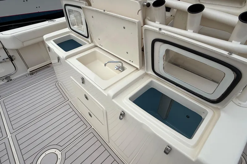 Slide: The Image of 2020 Grady-White Canyon 376 boat interior with sink and storage compartments. - 32