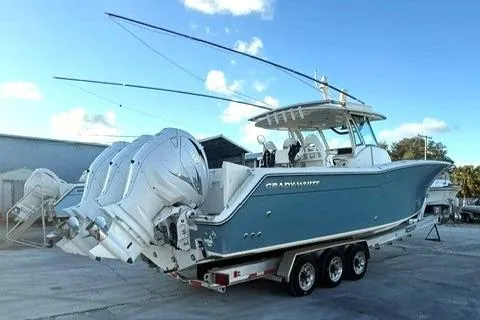 Slide: The Image of 2020 Grady-White Canyon 376 boat with radar and light bar, docked under cloudy skies. - 4