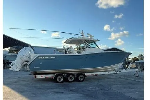 Slide: The Image of 2020 Grady-White Canyon 376 boat radar and equipment on deck, marina background. - 5