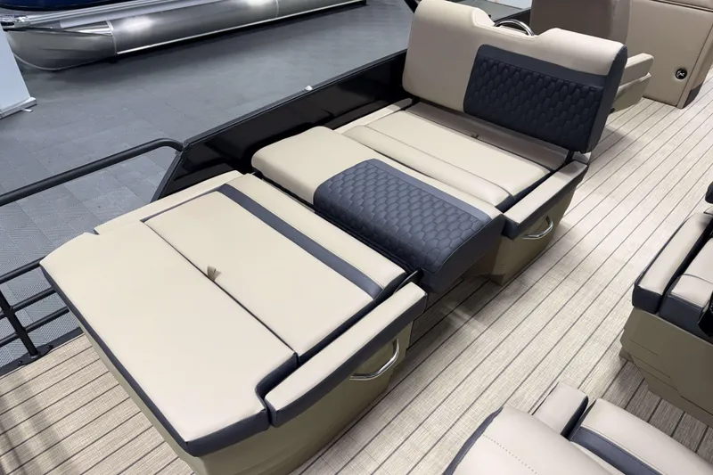 Slide: The Image of 2026 Sylvan L3 RLZ boat interior with beige and black cushioned seating. - 18