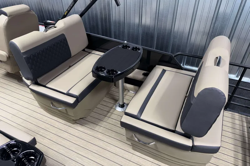 Slide: The Image of 2026 Sylvan L3 RLZ boat interior with beige seating and black table. - 19