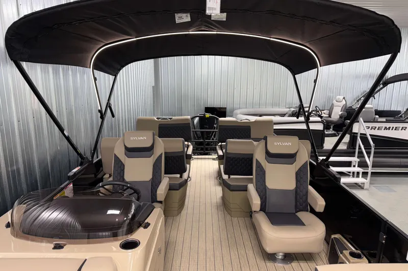 Slide: The Image of 2026 Sylvan L3 RLZ pontoon boat with luxurious seating and canopy in showroom. - 8
