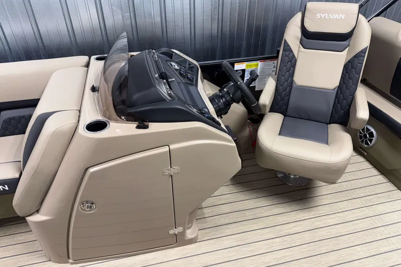 Slide: The Image of 2026 Sylvan L3 RLZ boat interior with beige captain's chair and control console. - 9
