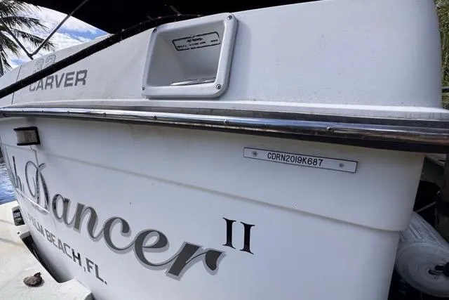 Slide: The Image of 1987 Carver 32 Aft Cabin Motor Yacht docked, showing "Dancer II" name and registration. - 13