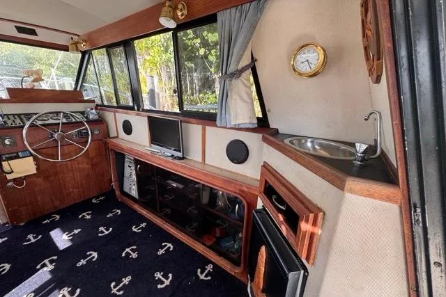 Slide: The Image of 1987 Carver 32 Aft Cabin Motor Yacht interior with helm, sink, and nautical decor. - 20