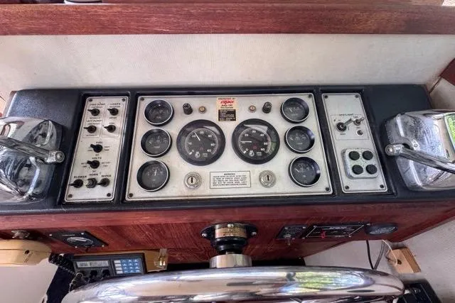 Slide: The Image of Control panel of a 1987 Carver 32 Aft Cabin Motor Yacht with gauges and switches. - 24