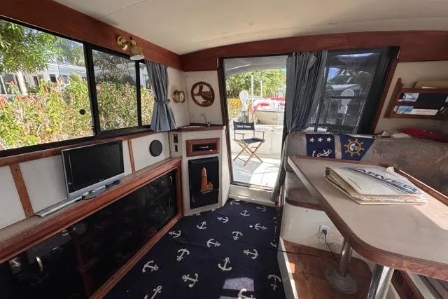 Slide: The Image of 1987 Carver 32 Aft Cabin Motor Yacht interior with nautical decor and seating area. - 27