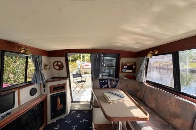 Slide: The Image of 1987 Carver 32 Aft Cabin Motor Yacht interior with cozy seating and nautical decor. - 28