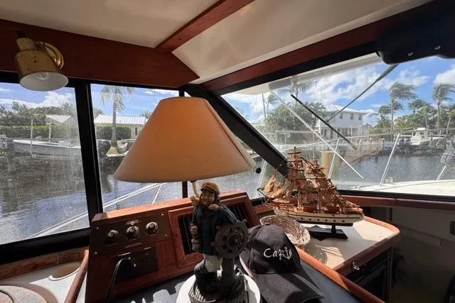 Slide: The Image of Interior of 1987 Carver 32 Aft Cabin Motor Yacht with nautical decor and marina view. - 30