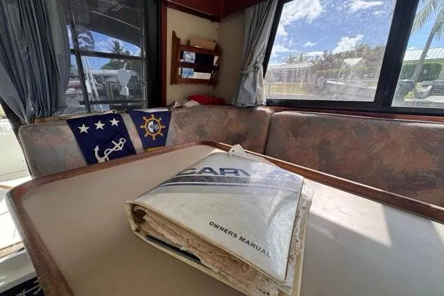 Slide: The Image of 1987 Carver 32 Aft Cabin Motor Yacht interior with owner's manual on table. - 31
