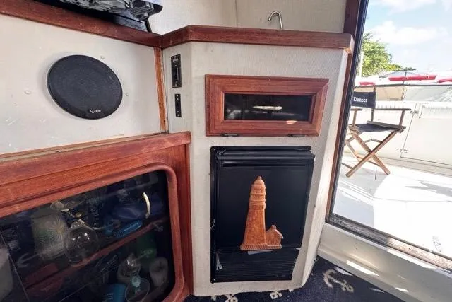 Slide: The Image of 1987 Carver 32 Aft Cabin Motor Yacht interior with wood accents and nautical decor. - 32