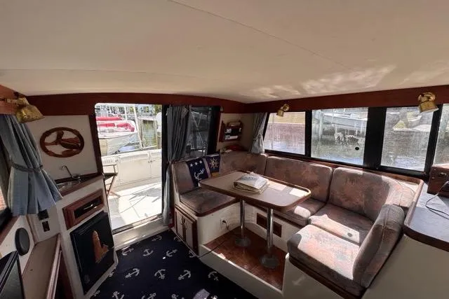 Slide: The Image of 1987 Carver 32 Aft Cabin Motor Yacht interior with cozy seating and nautical decor. - 37