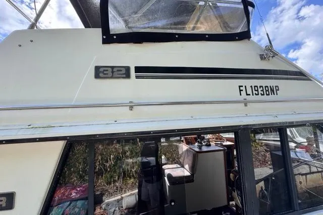 Slide: The Image of 1987 Carver 32 Aft Cabin Motor Yacht exterior with registration number FL1938NP. - 5