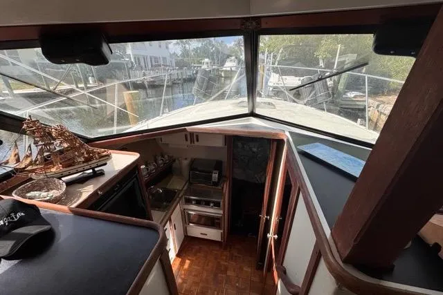 Slide: The Image of 1987 Carver 32 Aft Cabin Motor Yacht interior with kitchen and nautical decor. - 59