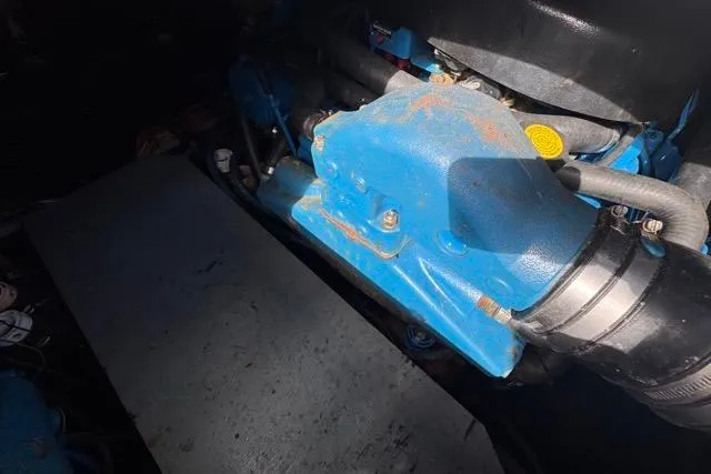 Slide: The Image of Engine compartment of 1987 Carver 32 Aft Cabin Motor Yacht, featuring blue engine components. - 73