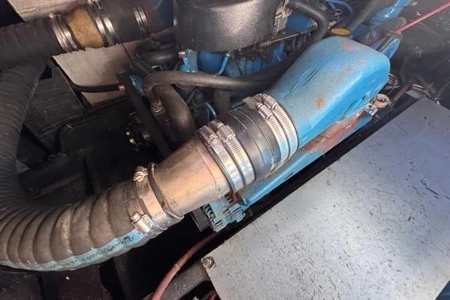 Slide: The Image of Engine compartment of a 1987 Carver 32 Aft Cabin Motor Yacht, showing hoses and clamps. - 74