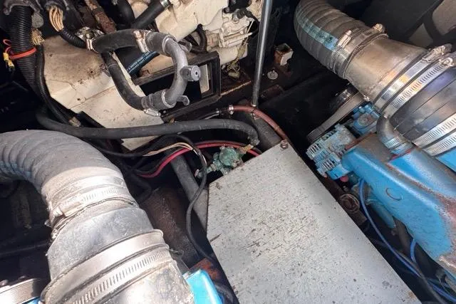 Slide: The Image of Engine compartment of 1987 Carver 32 Aft Cabin Motor Yacht, showing hoses and components. - 75
