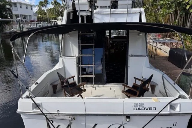Slide: The Image of 1987 Carver 32 Aft Cabin Motor Yacht docked, featuring spacious deck and seating. - 11
