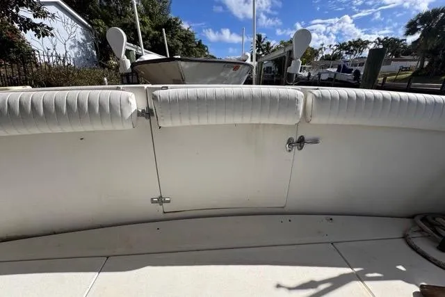 Slide: The Image of 1987 Carver 32 Aft Cabin Motor Yacht deck with white seating and clear sky. - 19