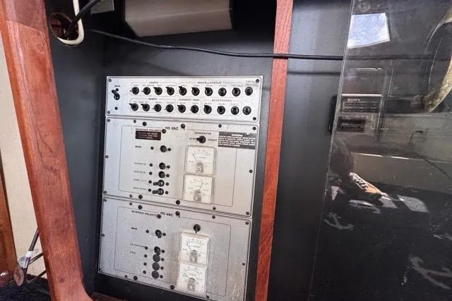 Slide: The Image of Electrical panel of 1987 Carver 32 Aft Cabin Motor Yacht, featuring switches and meters. - 33