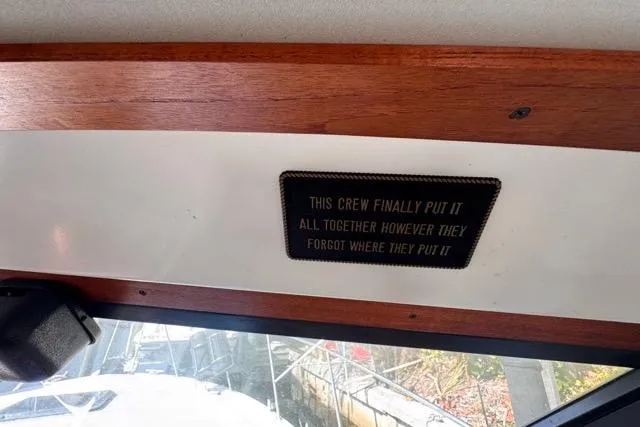 Slide: The Image of 1987 Carver 32 Aft Cabin Motor Yacht interior with humorous sign about crew organization. - 36
