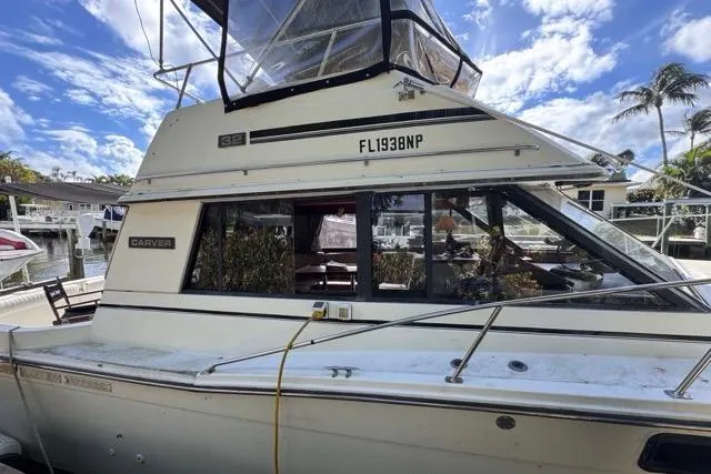 Slide: The Image of 1987 Carver 32 Aft Cabin Motor Yacht docked under a clear blue sky. - 4