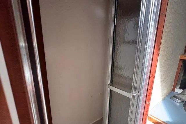 Slide: The Image of 1987 Carver 32 Aft Cabin Motor Yacht shower area with frosted glass door. - 51