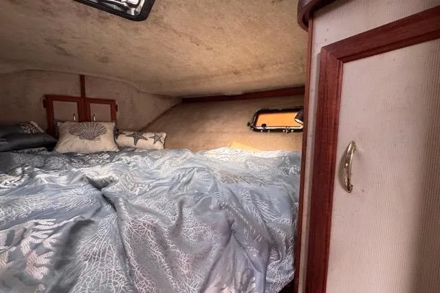 Slide: The Image of Cozy cabin interior of 1987 Carver 32 Aft Cabin Motor Yacht with bed and porthole. - 54