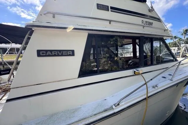 Slide: The Image of 1987 Carver 32 Aft Cabin Motor Yacht docked, showcasing sleek design and classic style. - 6