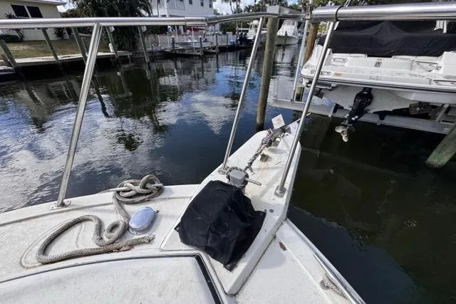 Slide: The Image of 1987 Carver 32 Aft Cabin Motor Yacht docked, showing bow with railing and ropes. - 67