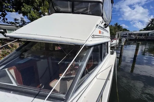 Slide: The Image of 1987 Carver 32 Aft Cabin Motor Yacht docked, showcasing sleek design and spacious cabin. - 71