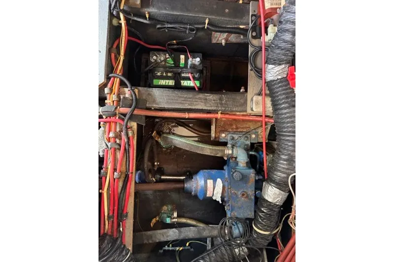 Slide: The Image of Engine compartment of 1987 Carver 32 Aft Cabin Motor Yacht with visible battery and wiring. - 77