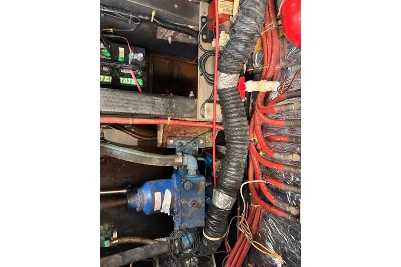 Slide: The Image of Engine room of 1987 Carver 32 Aft Cabin Motor Yacht with visible wiring and components. - 78