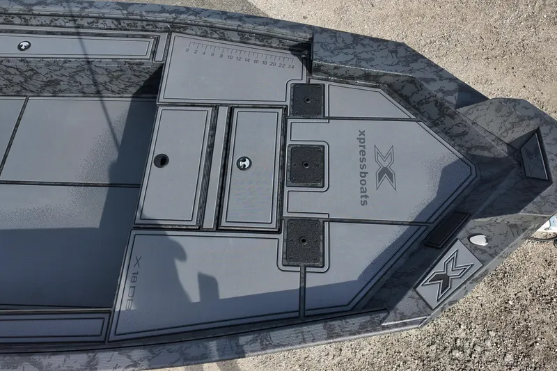 Slide: The Image of 2026 Xpress X18DB boat deck with storage compartments and measurement markings. - 10