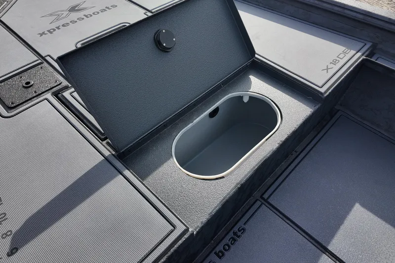 Slide: The Image of 2026 Xpress X18DB boat deck with open storage compartment. - 13