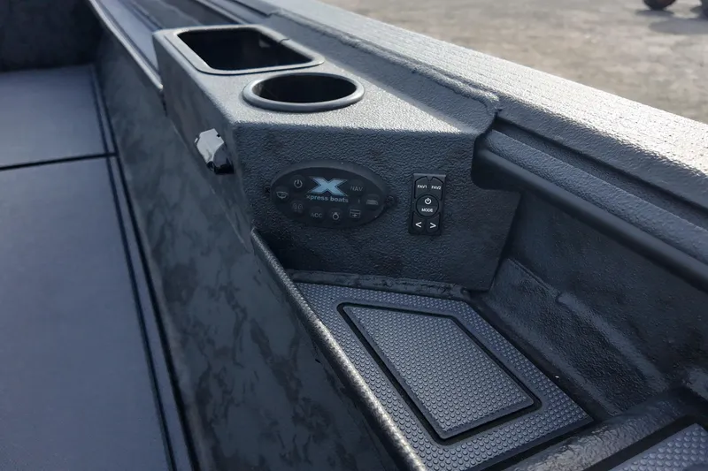 Slide: The Image of 2026 Xpress X18DB boat interior with control panel and cup holders. - 14