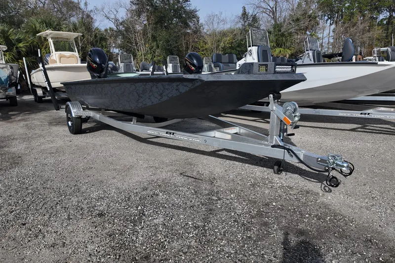 Slide: The Image of 2026 Xpress X18DB boat on trailer, parked outdoors, ready for transport. - 2