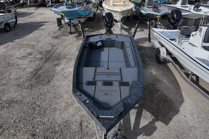 Slide: The Image of 2026 Xpress X18DB boat on display, featuring sleek design and modern amenities. - 6