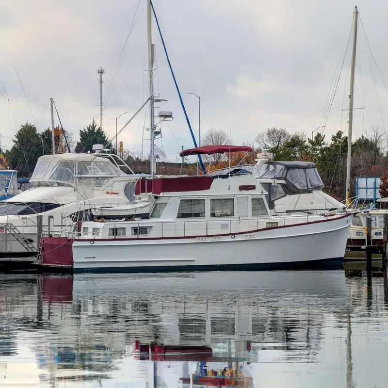 The Image of 1988 Grand Banks 46 Classic yacht docked in a marina, reflecting on calm water. - 0