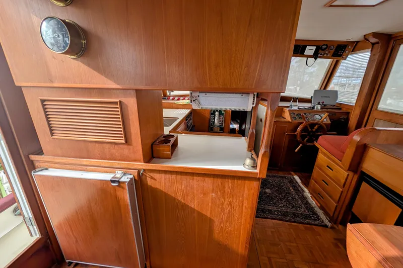 Slide: The Image of Interior of 1988 Grand Banks 46 Classic yacht with wooden cabinetry and helm station. - 10