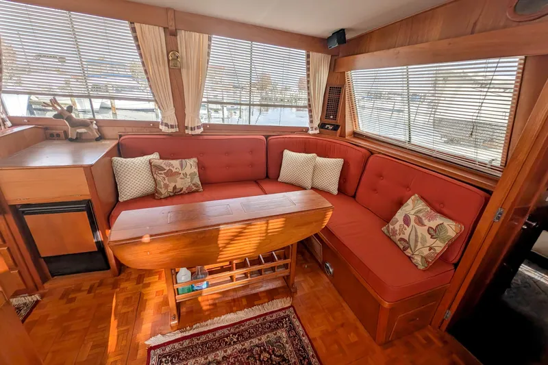 Slide: The Image of Interior of 1988 Grand Banks 46 Classic yacht with red seating and decorative pillows. - 11