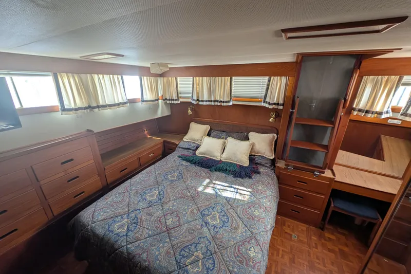 Slide: The Image of Luxurious cabin interior of 1988 Grand Banks 46 Classic yacht with cozy bed and wooden furnishings. - 14