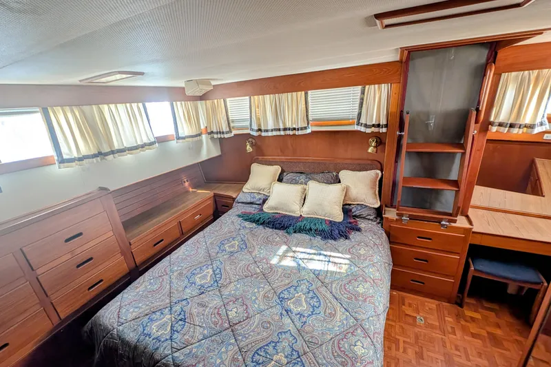 Slide: The Image of Luxurious cabin interior of 1988 Grand Banks 46 Classic yacht with cozy bed and wooden furnishings. - 15