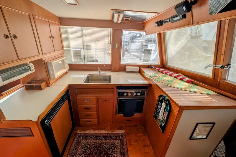 Slide: The Image of 1988 Grand Banks 46 Classic yacht kitchen with wood cabinetry, sink, and appliances. - 18