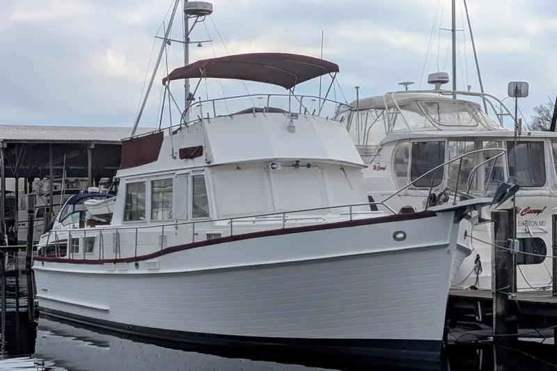 Slide: The Image of 1988 Grand Banks 46 Classic yacht docked at marina, featuring elegant design and spacious deck. - 2