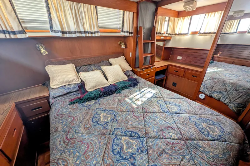 Slide: The Image of Cozy bedroom in 1988 Grand Banks 46 Classic yacht with patterned bedding and wooden furnishings. - 32