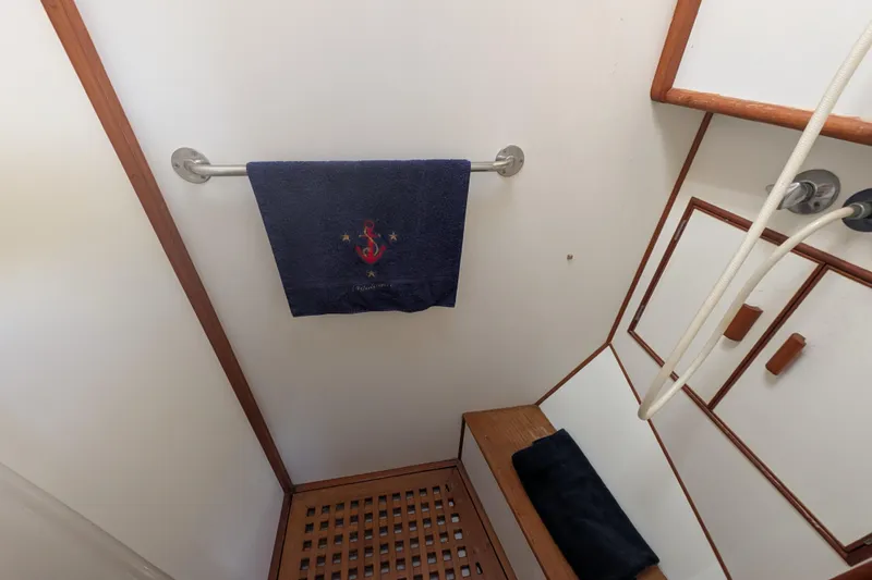 Slide: The Image of Shower area in 1988 Grand Banks 46 Classic yacht with towel and wooden accents. - 41