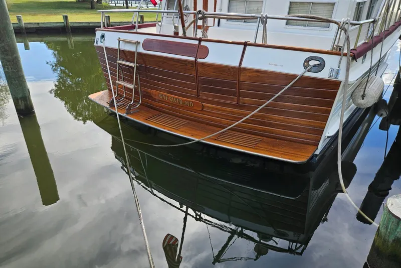 Slide: The Image of 1988 Grand Banks 46 Classic yacht docked, reflecting on calm water. - 51