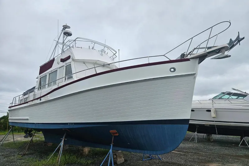 Slide: The Image of 1988 Grand Banks 46 Classic yacht on stands, white hull with blue bottom paint. - 53
